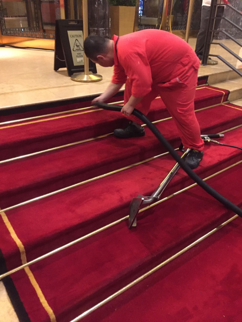 Cleaning a carpeted staircase in a Singapore building