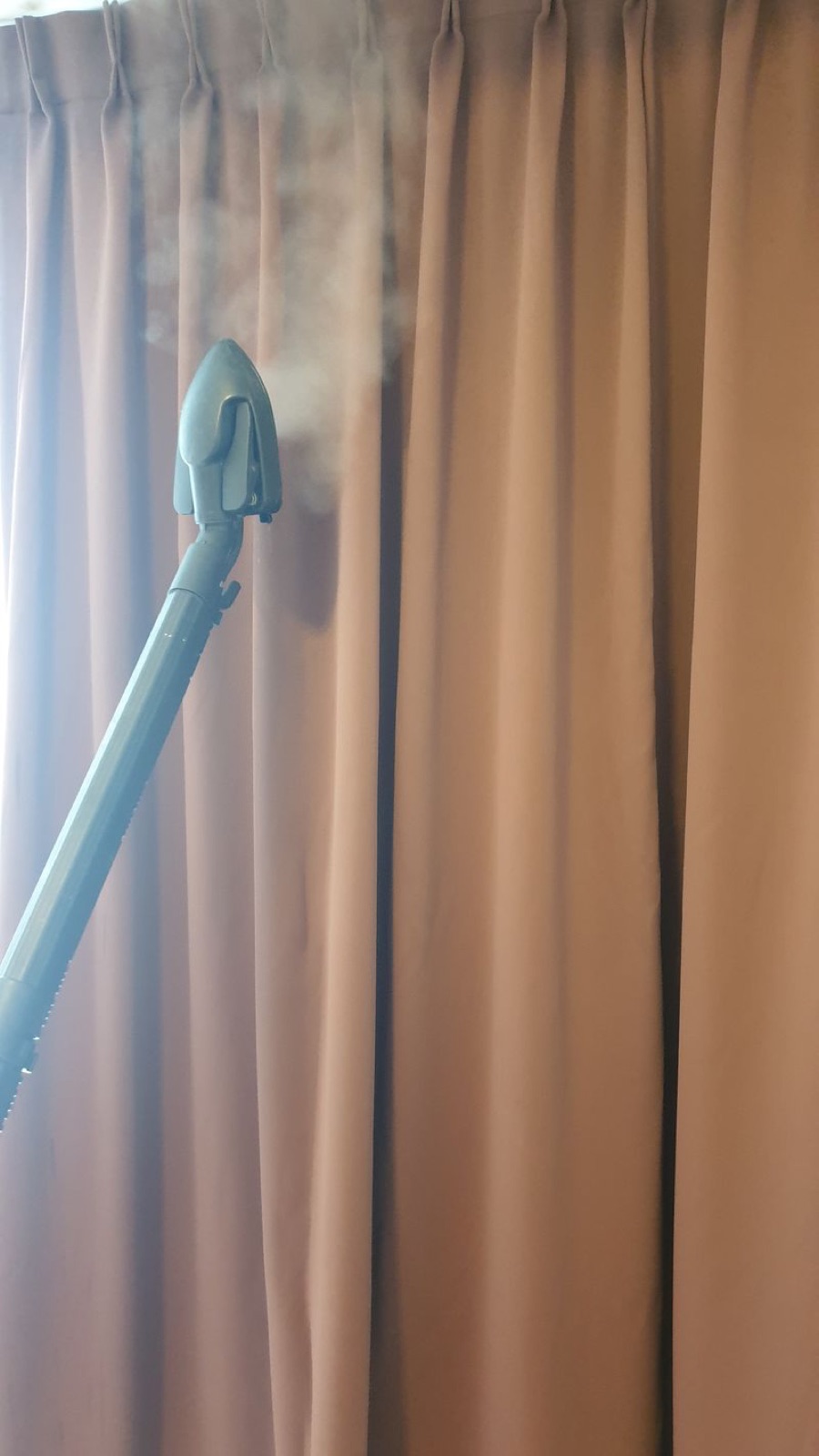 Steam cleaning curtains on-site, right where they hang