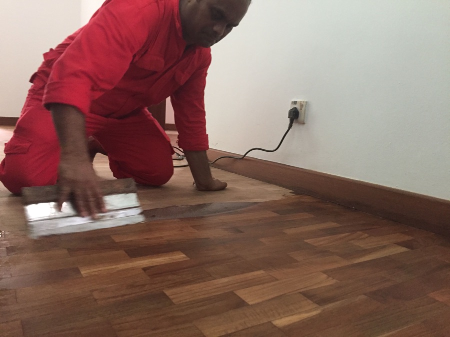 Big Red technician hand-finishing a parquet floor