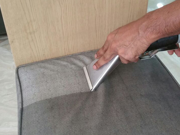 Cleaning a fabric chair in a Singapore living room