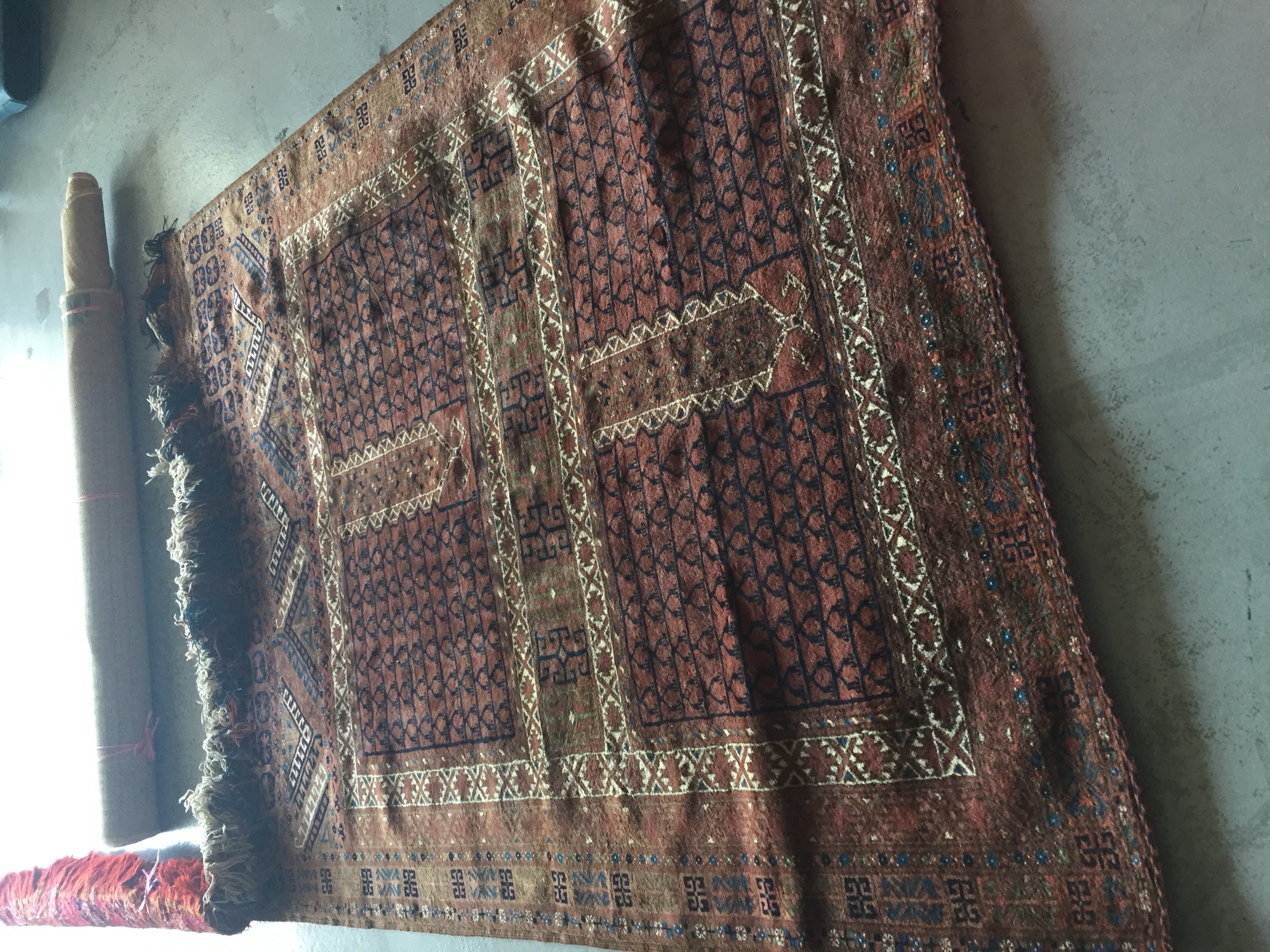 Natural jute rug on a tiled floor, showing the woven texture vulnerable to moisture damage