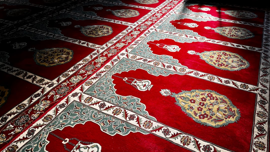 a red rug with a pattern on it