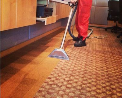 Big Red Carpet Cleaner vacuuming commercial space